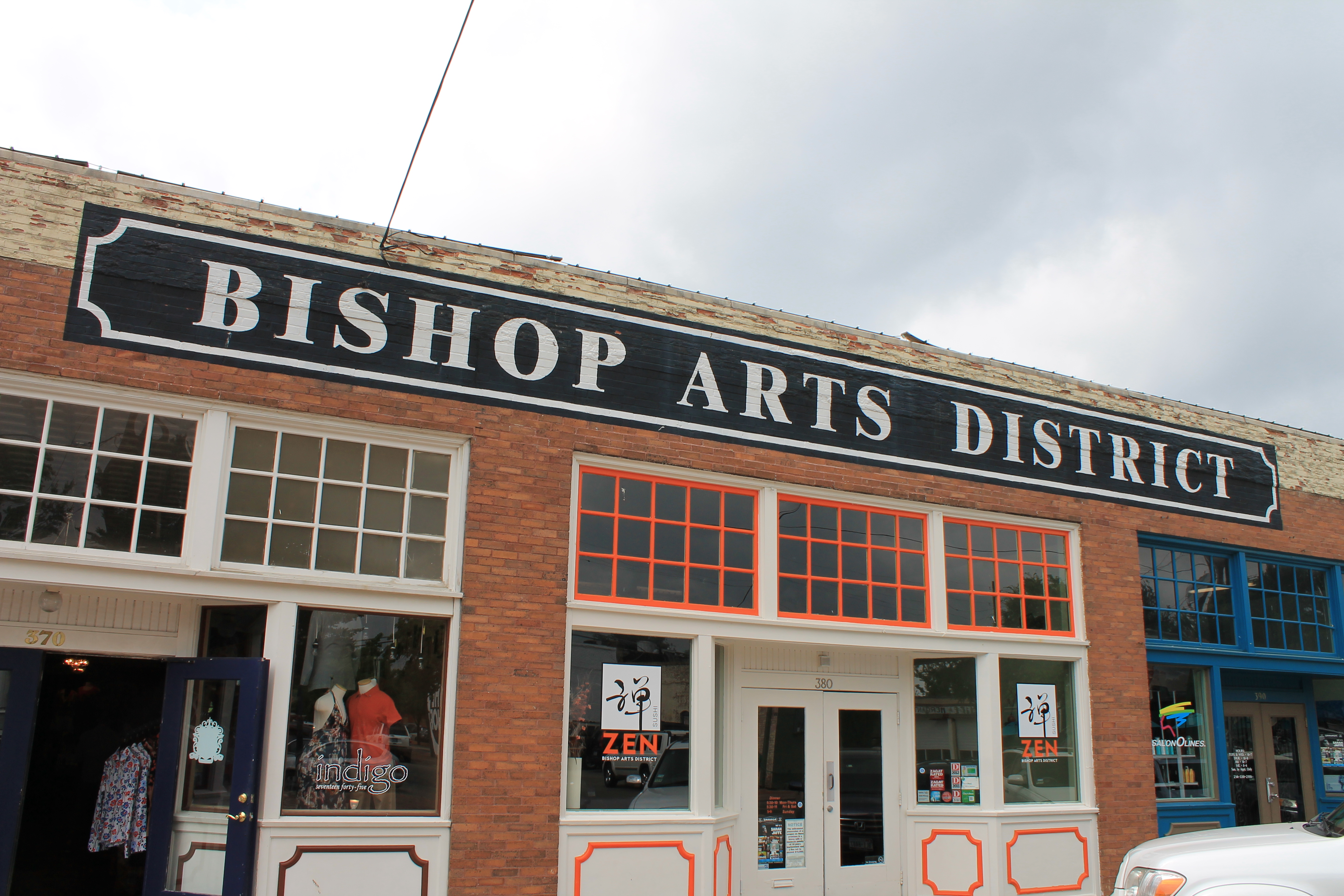 Brick storefronts and colorful windows along a street in Dallas’s Bishop Arts District.